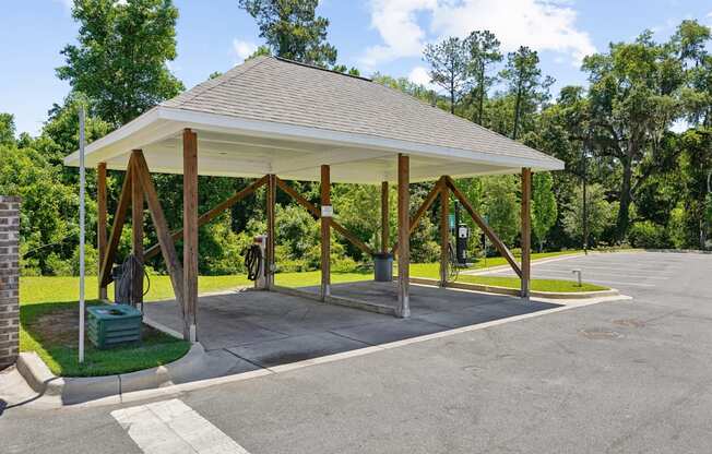 Covered car washing station with water hose and vacuum cleaners at Capital Grand Apartments in Tallahassee, FL