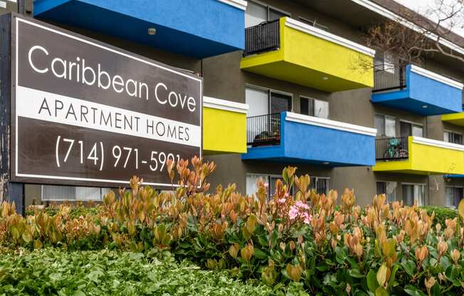 a building with a sign that reads caribbean cove apartment homes