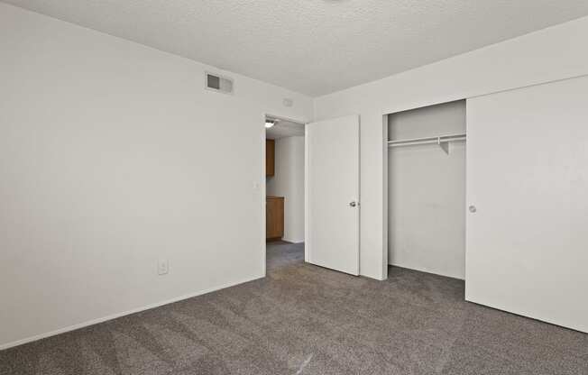 A room with a carpeted floor and a white door.