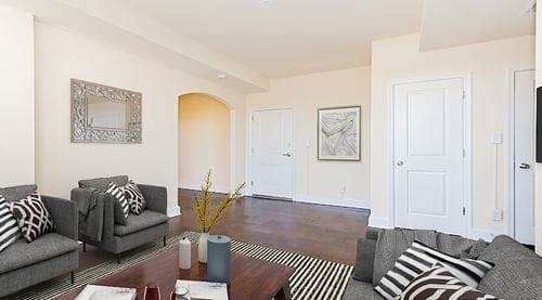 living area with sofa, coffee table, coat closet and hardwood floors at juniper courts apartments in takoma washington dc