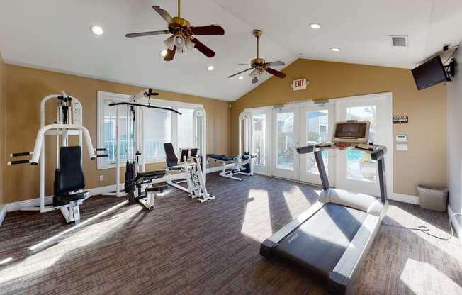 Pet Friendly Apartments in Ontario CA - Rancho Vista - Resident Gym With Two Ceiling Fans, a Treadmill, and Other Exercise Machines
