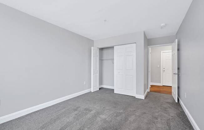 a room with a carpeted floor and a closet