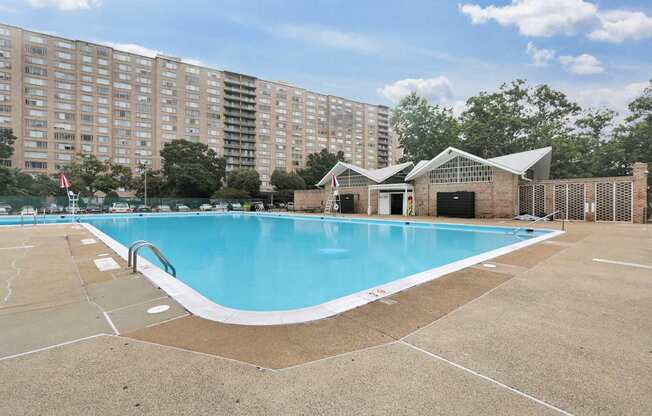 A large swimming pool in front of a building.