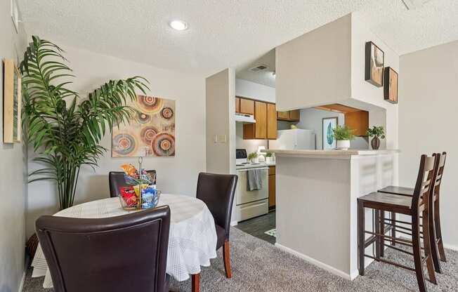 A dining room with a table and chairs.