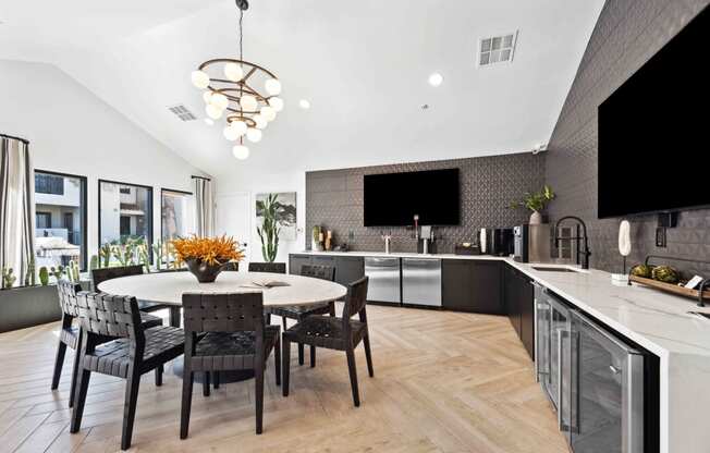 a kitchen and dining area with a table and chairs