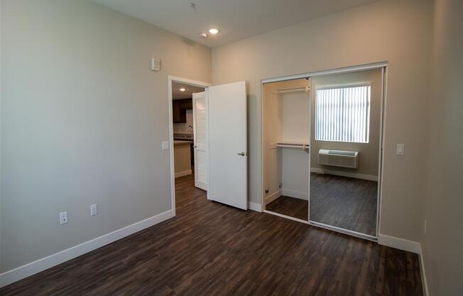 a bedroom with a large mirror and a closet at Loma Villas Apartments, San Bernardino California