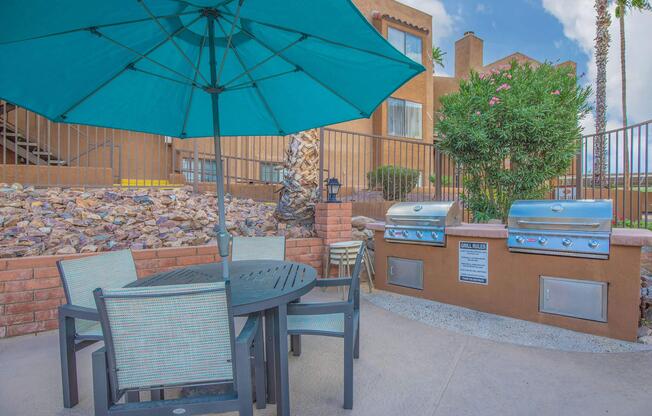 a table topped with a blue umbrella