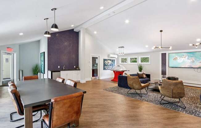 A conference room with a long table and chairs.