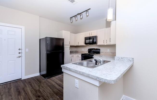 Apartments for Rent in Leander TX - Hills at Leander Spacious Kitchen with Plenty of Counterspace, Fully Equipped with Black Appliances, and Much More