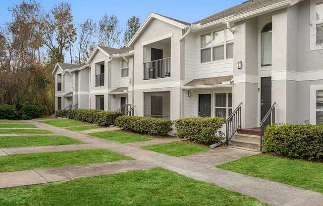 Apartment complex with a green lawn in front.