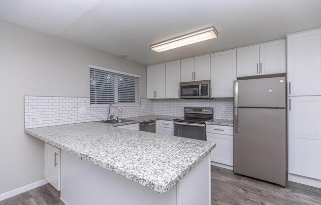 a kitchen with a sink and a refrigerator