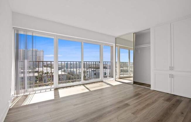 A room with a view of the city through large windows.
