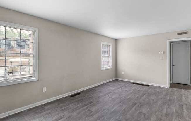 the living room of an empty house with a window and a door