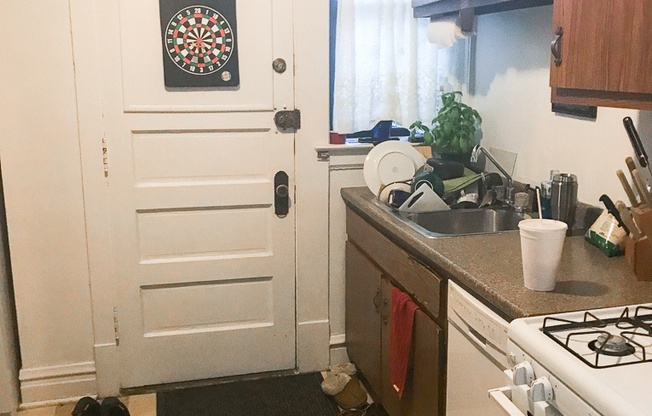 a kitchen with a door with a dart board on it
