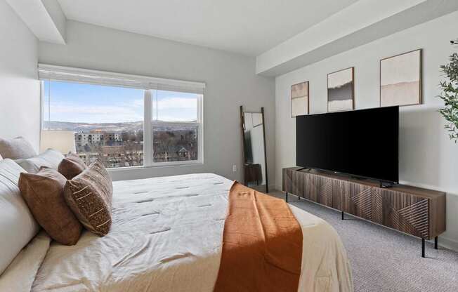 A bedroom with a large bed and a television at Wilmington Flats Apartments, Utah