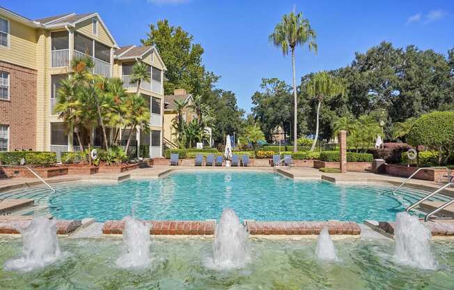 A pool with fountains in the middle of it.