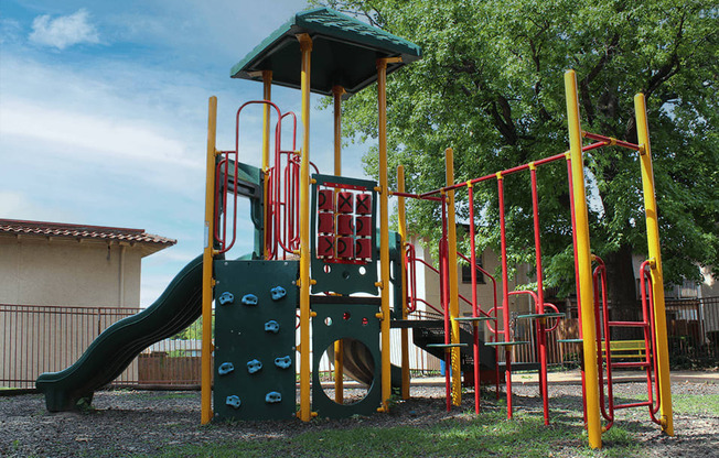 a playground with a slide and climbers