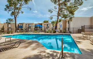 our resort style swimming pool is next to our buildings and trees