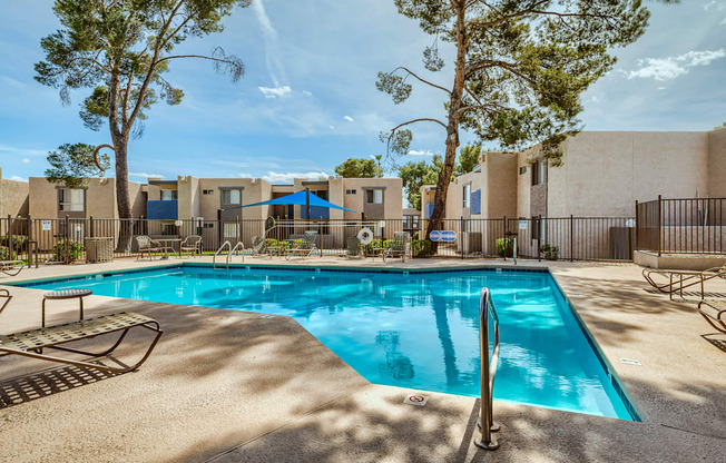 our resort style swimming pool is next to our buildings and trees