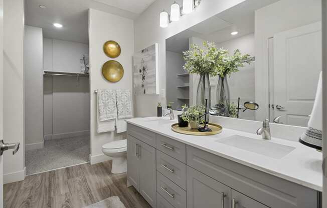 a bathroom with white cabinets and a white toilet at 200 City View, Provo, Utah