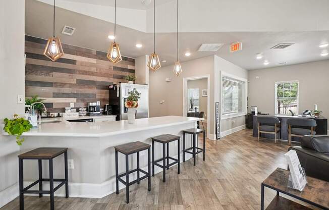 A kitchen with a bar area and a dining table.
