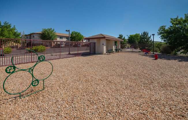 a tennis court with a tennis racket in front of a house