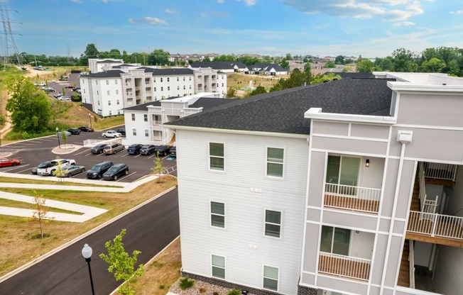 an aerial view of a building with a parking lot
