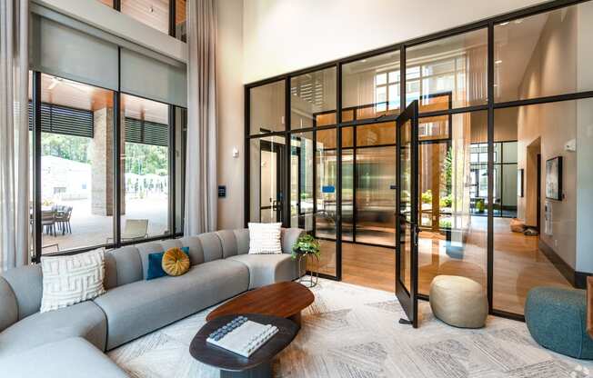 a living room with a gray couch and a coffee table at Preston Ridge, Cary, NC