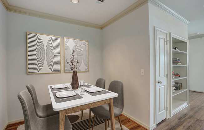 a dining room with a table and chairs and a door to a closet