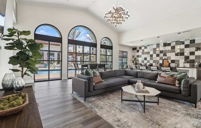 clubhouse that has large windows and a large couch and a coffee table at Arrive Temecula