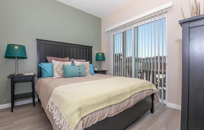 a bedroom with a bed and desk in a hotel room