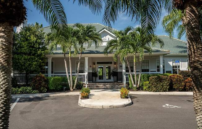 a large white building with palm trees in front of it