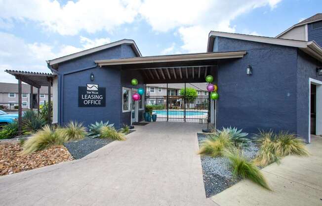 A blue building with a sign that says Leasing Office.