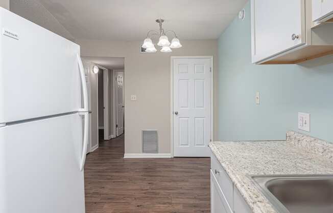 a kitchen with white cabinets and a black dishwasher