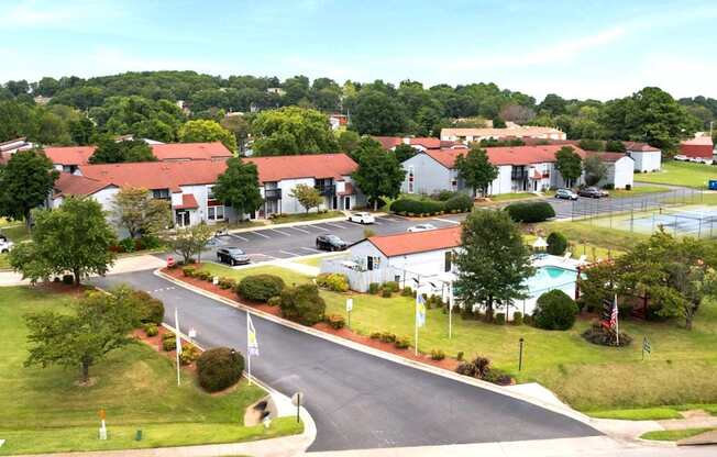A road with a flag on the side and a building in the background.