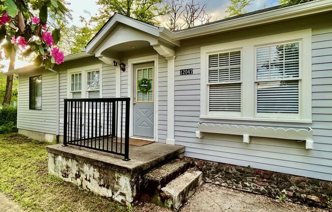 This 3-bedroom 1-bathroom house has a large front yard and a mostly fenced backyard.