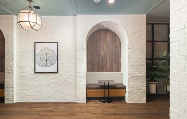 Private arched brick study area with small table and seating at Sylvan Uptown, Colorado, 80203