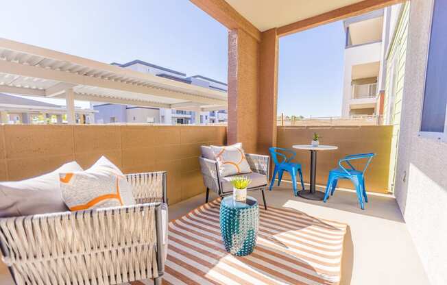 a patio with a table and chairs and a couch