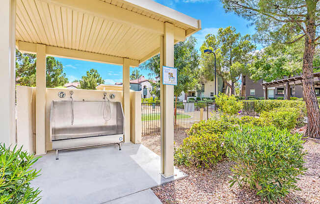 A hot tub is located under a covered patio area.