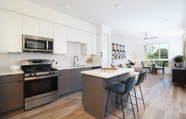 a kitchen with an island and a stove and a microwave