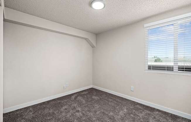 a bedroom with a large window