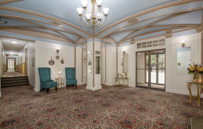 Lobby with Blue Painted Ceiling, Detailed Molding Work, Large Chandeliers, and Patterned Carpeting at Stockbridge Apartment Homes, Seattle, 98101