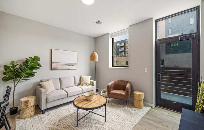 a living room with a white couch and a door to a balcony at EagleRidge Plaza Residences, Fargo, North Dakota