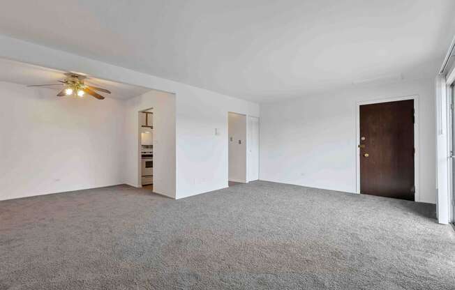 an empty bedroom with a ceiling fan