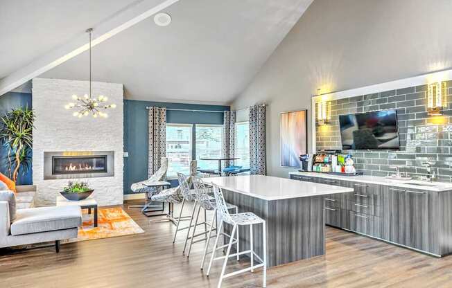 A modern kitchen with a fireplace and a dining area.