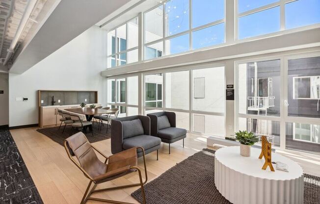 Indoor lounge and dining area with large sun windows at TL Residences