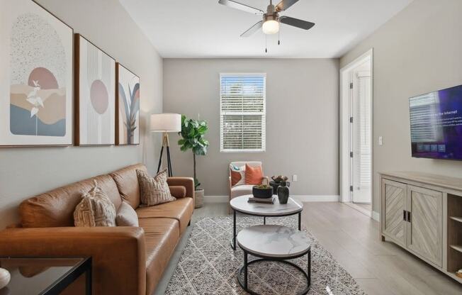 a living room with a couch and a ceiling fan at Arrive Temecula