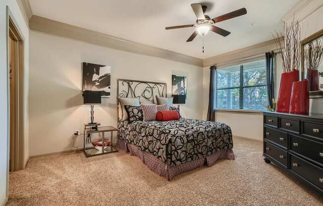 a bedroom with ceiling fan and walk-in closet