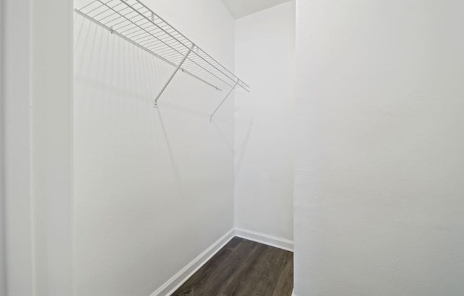 a bedroom with a medium hardwood floor and white walls