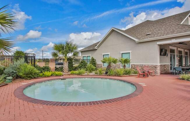 a small pool in a backyard in front of a house at Sladestone Shadow Creek, Texas, 77584